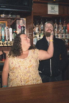 Mike Brown and Sunyin Marci stand behind The Jackalope Lounge. 