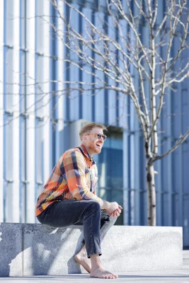 Aaron Gough sits on stairs outside.