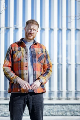 Aaron Gough stands outside looking at the camera.