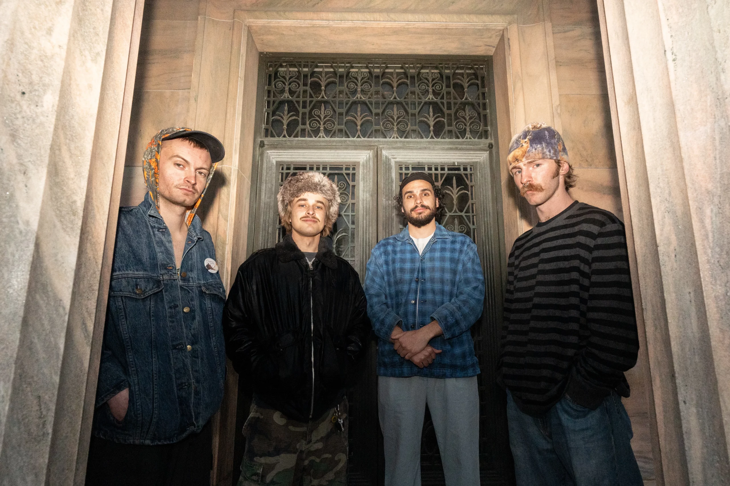 Olympic Deth standing in front of a door.