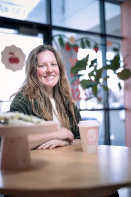 Cori Norton sits at a table inside Pie Party.