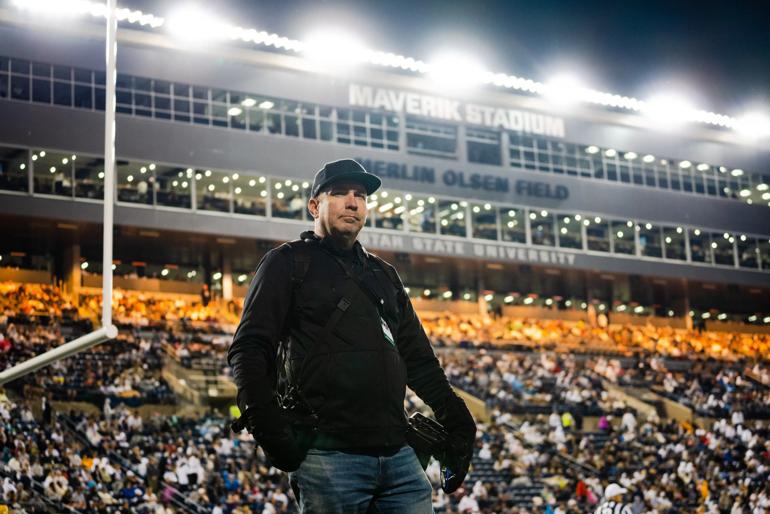 Joe Oliver stands at Utah State University’s Maverik Stadium during an Aggies football game.