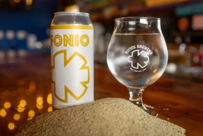 Close up of the Fonio can with a Kiitos Brewing glass beside it.