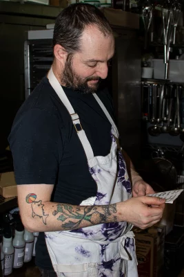 Andrew Fuller reads an order ticket. 