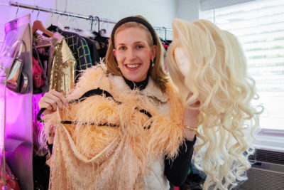Ms. Meredith poses with wig and dress.