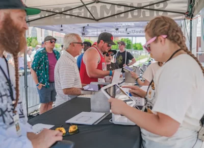 The crowds start filling in at event kickoff with volunteers ready to go. Photo: Talyn Behzad.