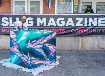 Benjamin, a local artist, creates art while jamming to a live DJ. Photo: Chay Mosqueda.