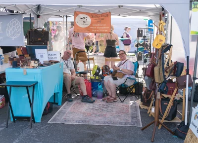 (Left to right) Glen Brown and Linda Lyman have all your leather needs covered. Anything from purses and wallets to belts and backpacks. Photo: Chay Mosqueda.