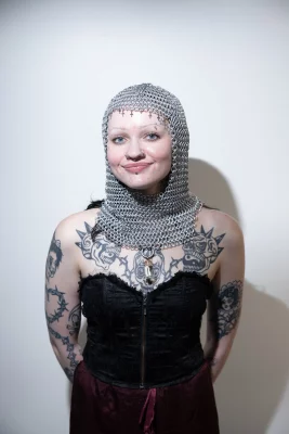 Chelsea wears a chainmail hood she created.