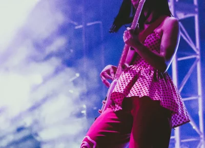 Laura Lee Ochoea mid-step while playing the bass.