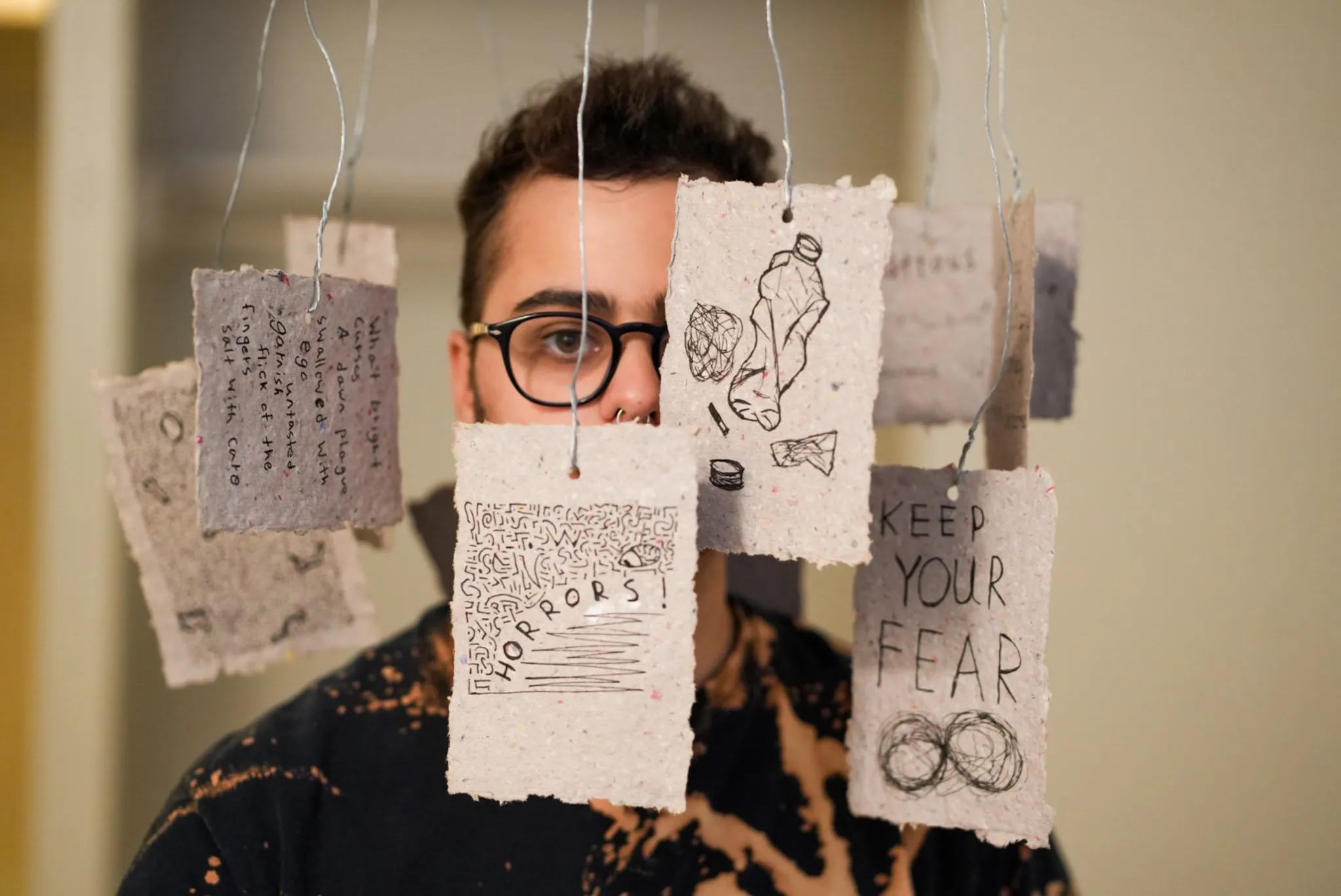 Lewis Figun Westbrook poses with their mobile-inspired art piece.