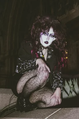 Cherry Poppins crouches and stares into the camera.