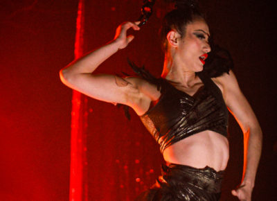 Jax Creative, Mother of the House of Temptations, demonstrating their incredible skill as a hair suspension artist.