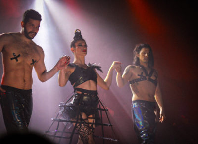 Walking towards the front of the stage after a costume change (L-R) Antonio, Jax Creative, and Mr. Creative stare look out at the crowd.