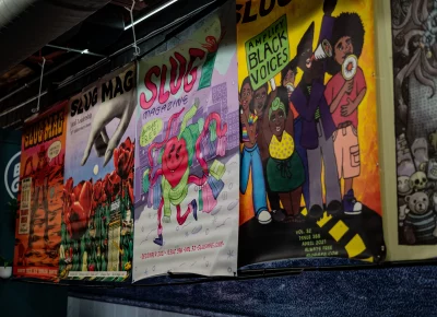 Oversized old SLUG Mag covers line the walls at Blue Gene’s.