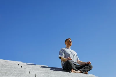 Aaron Gough sits on stairs outside.