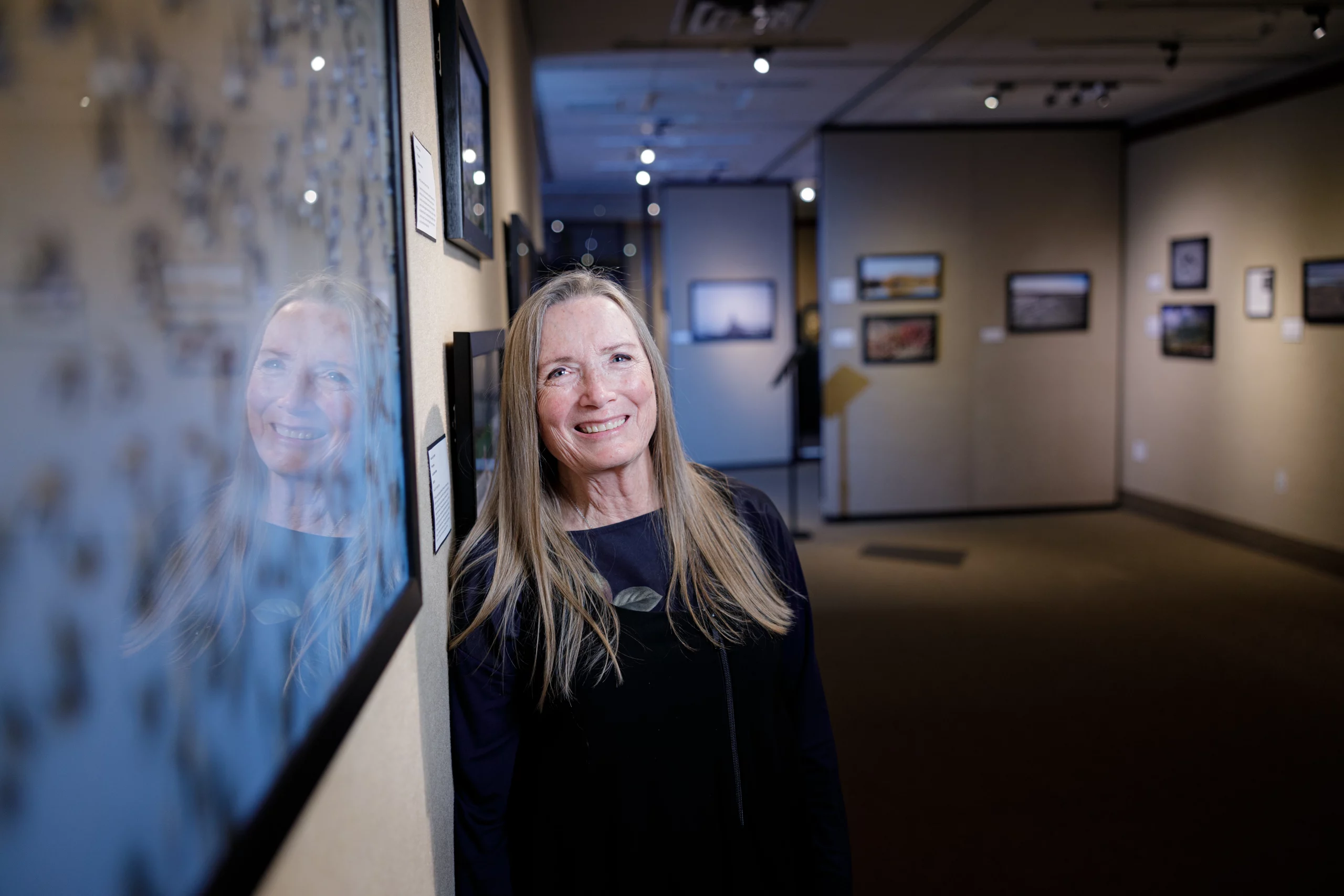 Linda Dalton Walker stands in a gallery.