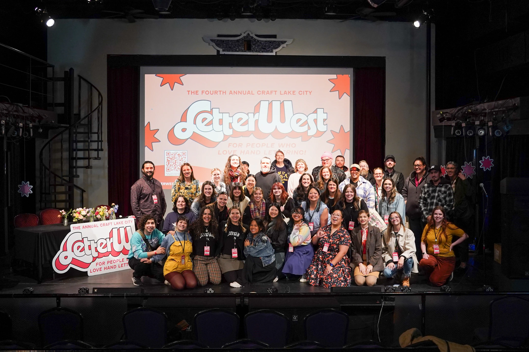 The people who organized LetterWest onstage for a photo.