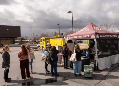 Attendees line up for food in front of Dang Brother Pizza's stand. Can't letter without some pizza. Photo: Derek Brad