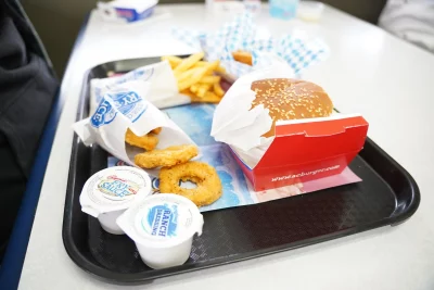 A plate of fast food on a tray. 