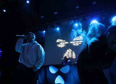 Kneecap members móglaí bap and Mo Chara at front of stage and fellow band mate DJ Próvaí is at the back of stage, performing in Salt Lake City, Utah at The Depot. Photo: Logan Sorenson.