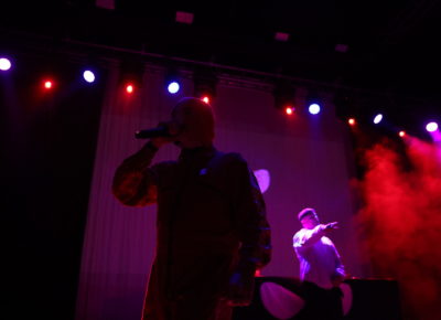 Kneecap’s móglaí bap posing a cheers to the audience in Salt Lake City, while performing on stage at The Depot. Photo: Logan Sorenson.