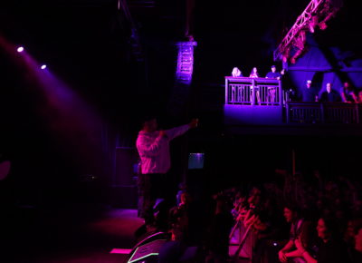 Kneecap’s DJ Próvaí takes the mic early and sings to the audience as he points to the packed house. Photo: Logan Sorenson.