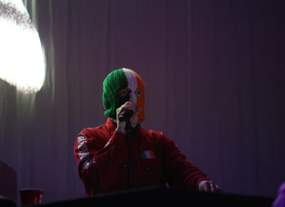 Kneecap’s DJ Próvaí sports an Irish Flag Colored balaclava while on stage in Salt Lake City at the Depot. Photo: Logan Sorenson.