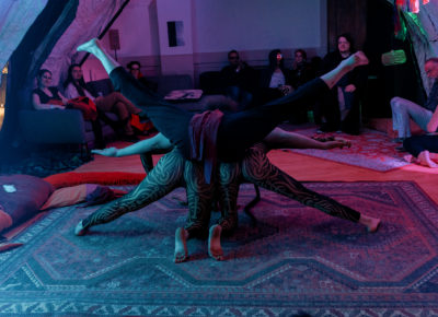 Spontaneous acro-yoga takes place in one of the areas of the venue. Photo: Emily Sorensen.