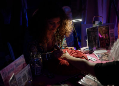 Consuelo Nikolazza offers henna tattoos in one area of the cabaret. Photo: Emily Sorensen.