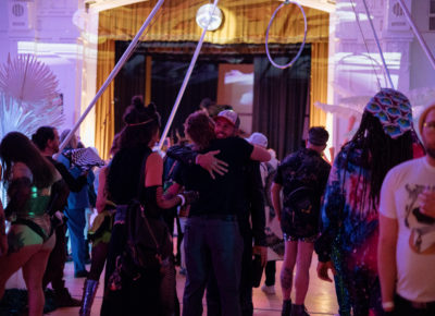 Friends give warm embraces as people come and go throughout the night. Photo: Emily Sorensen.