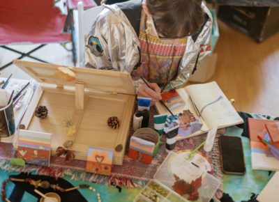 Helena Gaffney of Alive Art by Helena paints while she spends time at the Craft Market. Photo: Emily Sorensen.