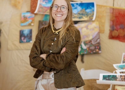 Annie Platt of Annie Platt Art poses in front of her art display. Photo: Emily Sorensen.