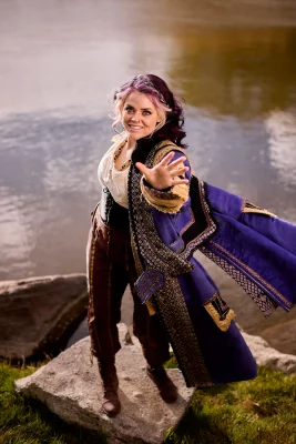 An actor in theatre dress by the river.