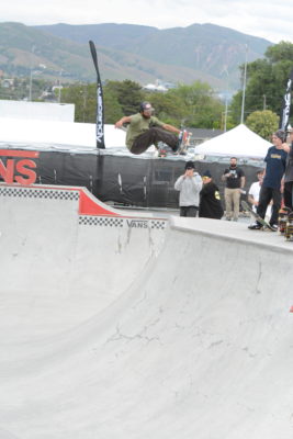 Man flies through the air on a skateboard.