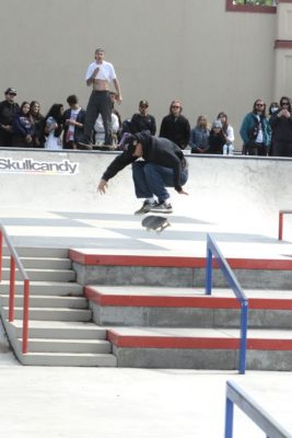 Man hits a kickflip on a skateboard.