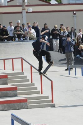 Man grinds rail on skateboard