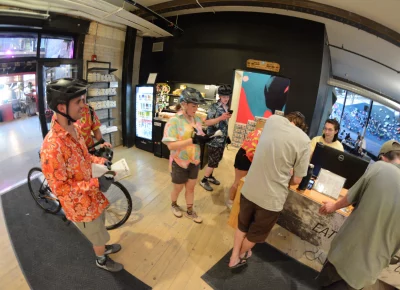 Cyclists inside the lobby of a climbing gym.
