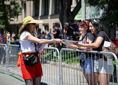 Angela H. Brown handing out June's issue to parade attendees. Photo: TaCara DeTevis.