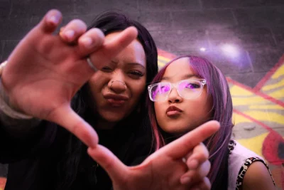 Cyndi and Celeste making a frame with their fingers.